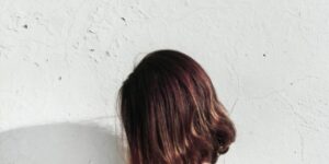 Image of the side of a lady with dark bobbed hair