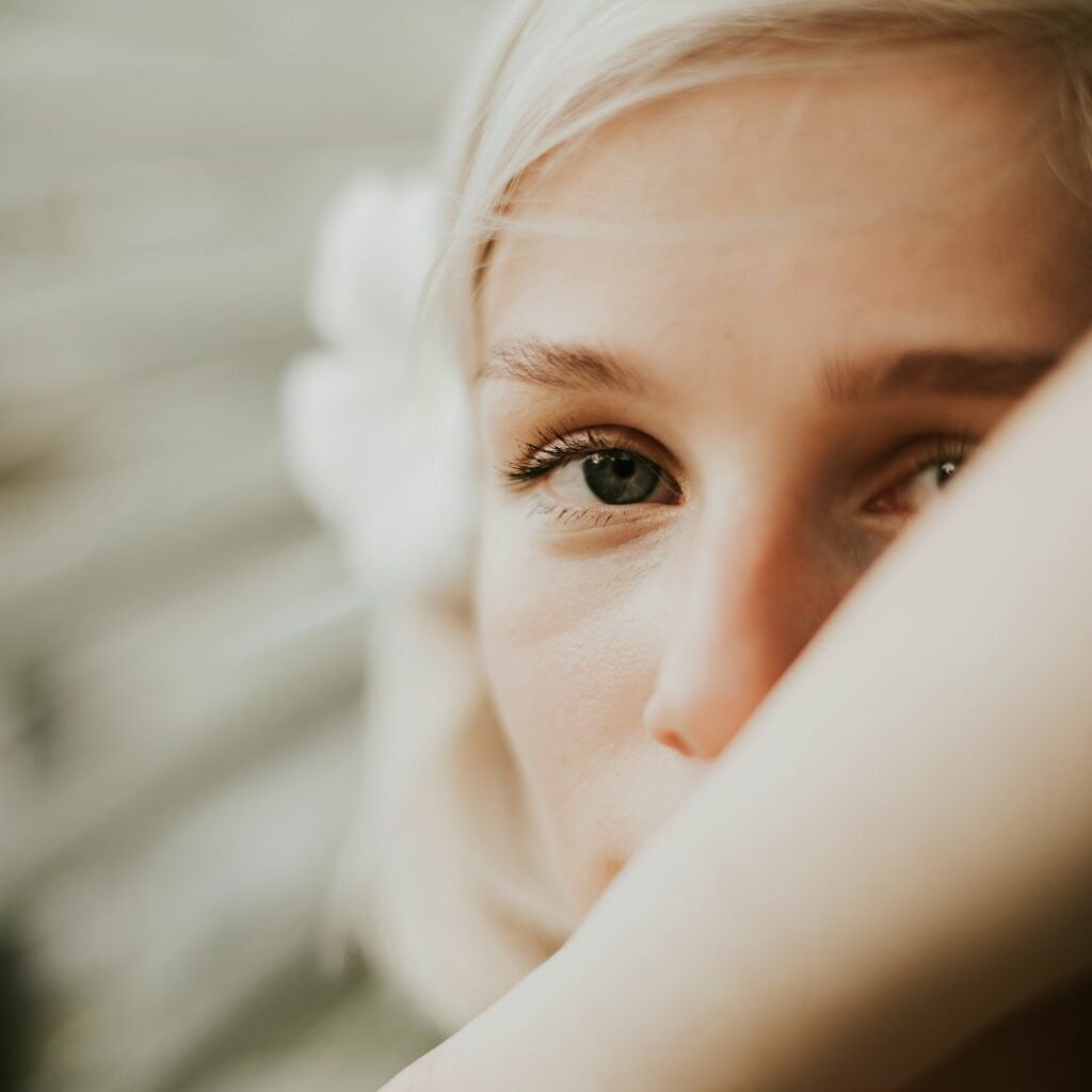 Lady with her arm over her face